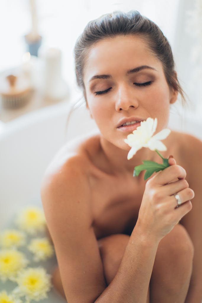 Contact 1 A woman enjoying a relaxing spa bath, surrounded by white flowers, embracing tranquility and self-care.